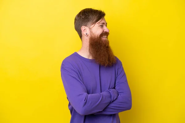 stock image Redhead man with beard isolated on yellow background looking side