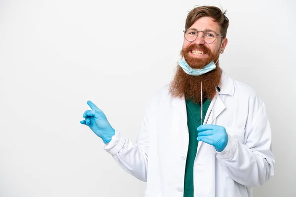 Стоматолог Красноватый Человек Держит Инструменты Изолированы Белом Фоне Указывая Назад — стоковое фото