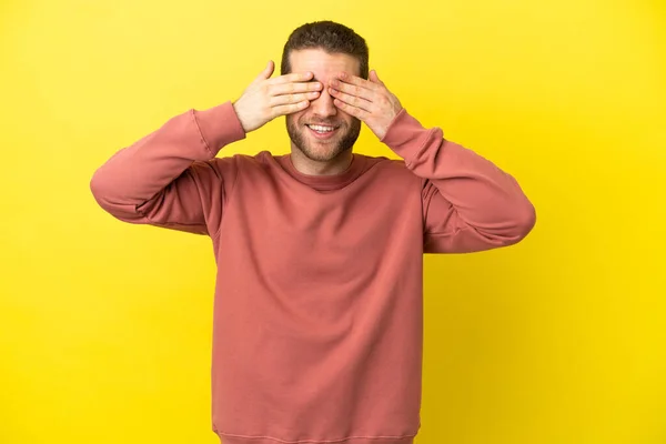 Handsome Blonde Man Isolated Yellow Background Covering Eyes Hands Smiling — Stok fotoğraf