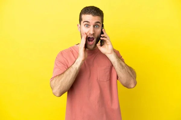 Handsome Blonde Man Using Mobile Phone Isolated Background Surprise Shocked — Stock Photo, Image
