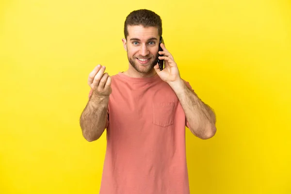 Handsome Blonde Man Using Mobile Phone Isolated Background Making Money — Stock Photo, Image