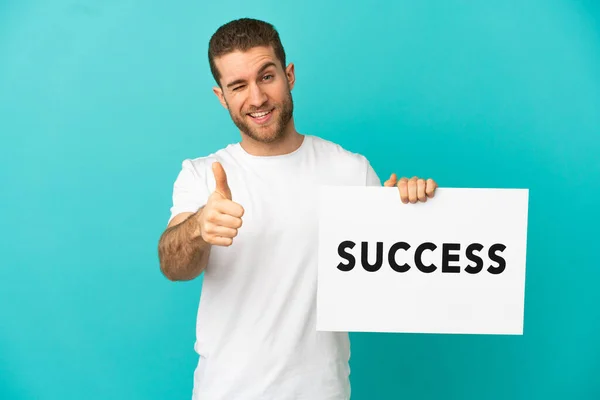 Handsome Blonde Man Isolated Blue Background Holding Placard Text Success —  Fotos de Stock