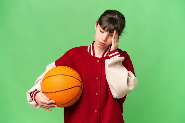 小さなCaucasian女の子プレイバスケットボール上の隔離された背景とともに頭痛 — ストック写真
