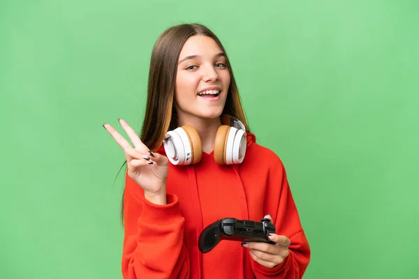 ティーンCaucasian女の子遊びますとともにAビデオゲームコントローラ上の隔離された背景笑顔とショー勝利サイン — ストック写真