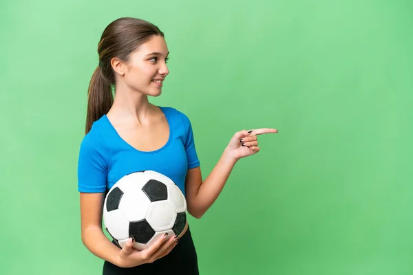 Teenager Caucasian Girl Playing Football Isolated Background Pointing Side Present — Stock Photo, Image