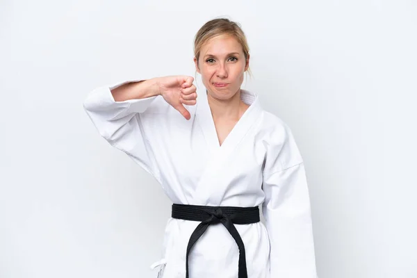 stock image Young caucasian woman doing karate isolated on white background showing thumb down with negative expression