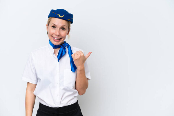 Airplane blonde stewardess woman isolated on white background pointing to the side to present a product