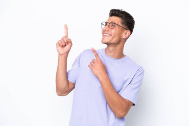 Young caucasian man isolated on white background pointing with the index finger a great idea