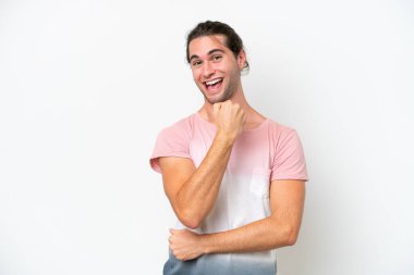Caucasian handsome man isolated on white background celebrating a victory