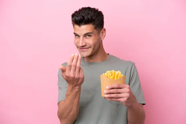 Jonge Blanke Man Met Gebakken Chips Geïsoleerd Roze Achtergrond Uitnodigend — Stockfoto