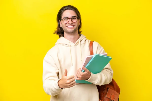 Young Student Handsome Man Isolated Yellow Background Giving Thumbs Gesture — Foto de Stock