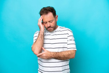 Kafkasyalı orta yaşlı bir adam mavi arka planda baş ağrısı ile izole edilmiş.