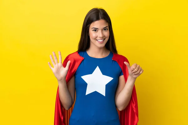 stock image Super Hero Brazilian woman isolated on yellow background counting six with fingers