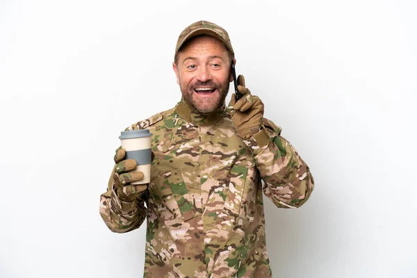 Military man isolated on white background holding coffee to take away and a mobile