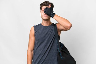 Young sport caucasian man with sport bag over isolated white background covering eyes by hands. Do not want to see something