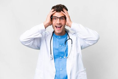 Young doctor man over isolated white background with surprise expression