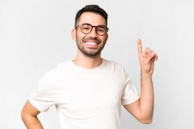Young handsome caucasian man over isolated white background showing and lifting a finger in sign of the best