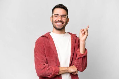 Young handsome caucasian man over isolated white background happy and pointing up