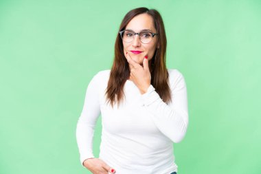 Middle age woman over isolated chroma key background thinking
