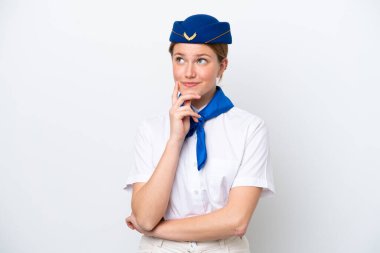 Airplane stewardess woman isolated on white background thinking an idea while looking up
