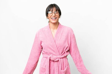 Young woman in a bathrobe over isolated white background laughing