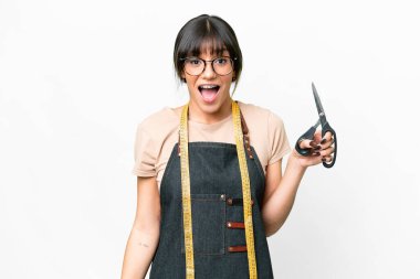 Young caucasian seamstress over isolated white background with surprise facial expression