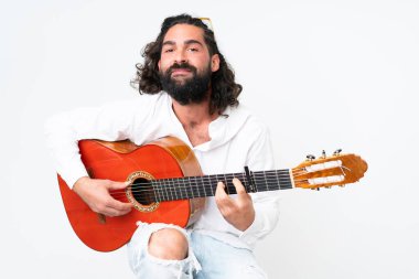 Young man with beard playing guitar on white background