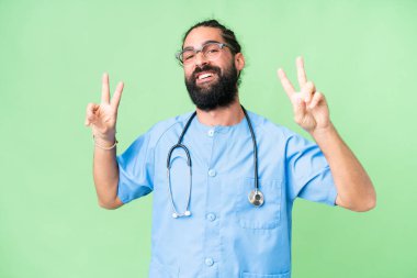 Young doctor man over isolated chroma key background showing victory sign with both hands