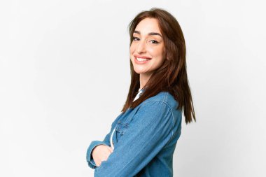 Young caucasian woman over isolated white background with arms crossed and looking forward