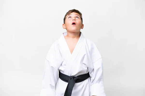 Pequeño Niño Caucásico Haciendo Karate Sobre Fondo Blanco Aislado Mirando —  Fotos de Stock
