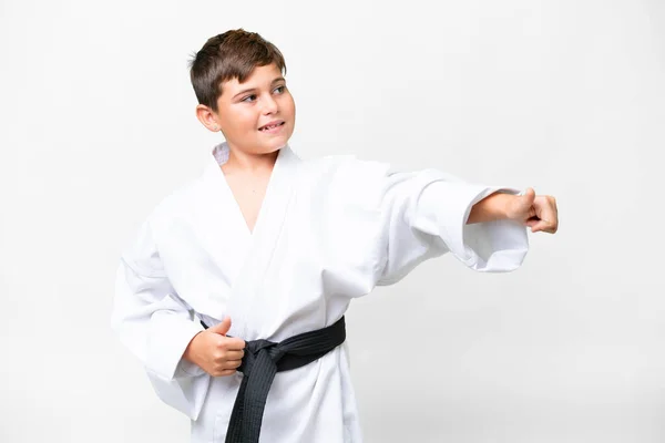 stock image Little caucasian kid doing karate over isolated white background giving a thumbs up gesture