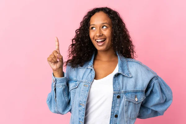 Teenager cuban girl isolated on pink background intending to realizes the solution while lifting a finger up
