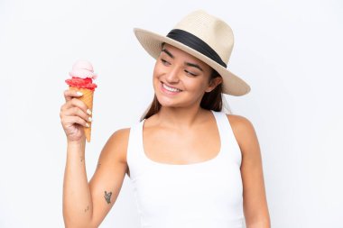 Young caucasian woman with a cornet ice cream isolated on white background with happy expression