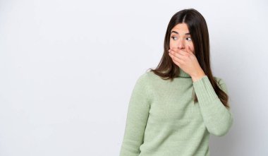 Beyaz arka planda izole edilmiş genç Brezilyalı kadın yan tarafa bakarken sürpriz jest yapıyor.