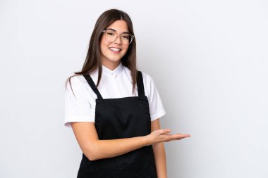 Restaurant Brazilian waiter woman isolated on white background presenting an idea while looking smiling towards