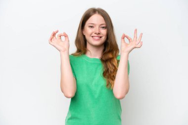 Young pretty woman isolated on white background showing ok sign with two hands