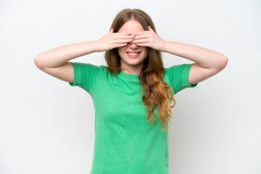 Young pretty woman isolated on white background covering eyes by hands and smiling
