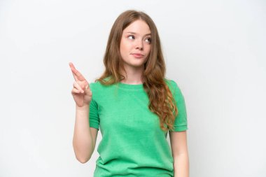 Young pretty woman isolated on white background with fingers crossing and wishing the best