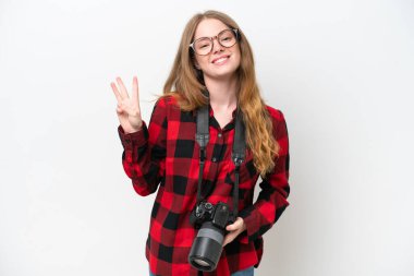 Young photographer pretty woman isolated on white background happy and counting three with fingers
