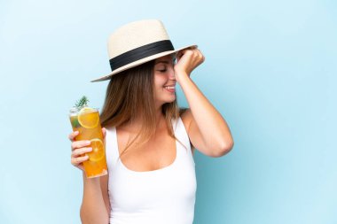 Young beautiful woman holding a cocktail isolated on blue background has realized something and intending the solution