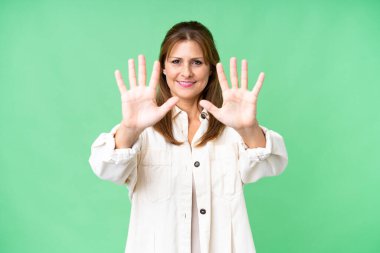 Middle age woman over isolated background counting ten with fingers