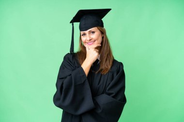Middle age university graduate woman over isolated background smiling
