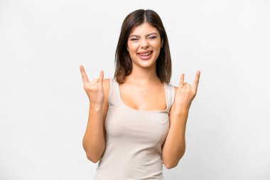 Young Russian woman over isolated white background making horn gesture
