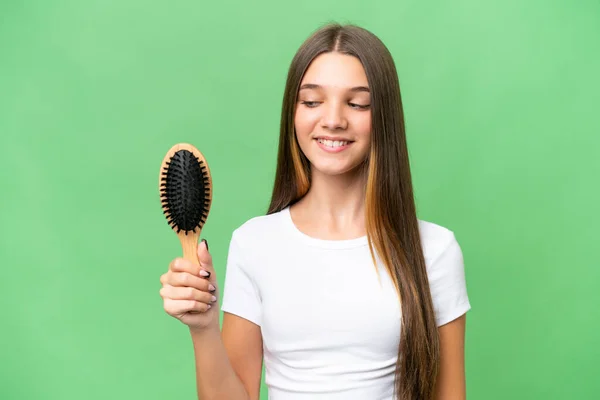 Teenager caucasian girl with hair comb over isolated background with happy expression