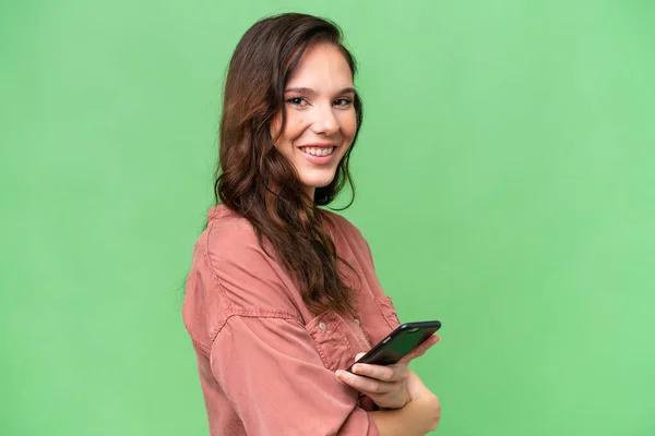Young Caucasian Woman Isolated Background Holding Mobile Phone Arms Crossed — Photo