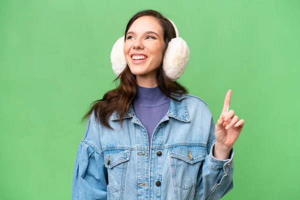 Young Caucasian Woman Wearing Winter Muffs Isolated Background Pointing Surprised — Photo