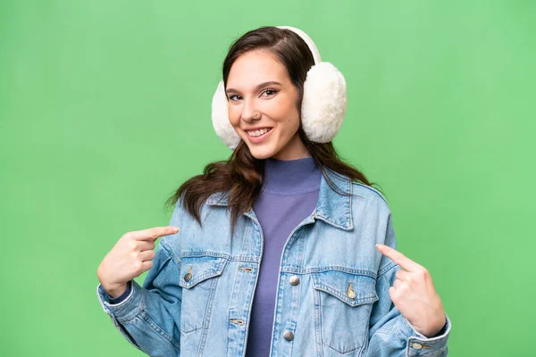 Young Caucasian Woman Wearing Winter Muffs Isolated Background Proud Self — Photo