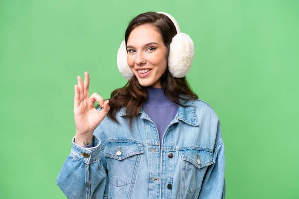 Young Caucasian Woman Wearing Winter Muffs Isolated Background Showing Sign — Photo
