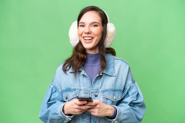 Young Caucasian Woman Wearing Winter Muffs Isolated Background Surprised Sending — Photo