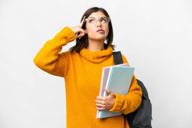 Young student woman over isolated white background having doubts and thinking